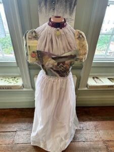 A full size model dressed in fabric as per the desription, placed in between two windows